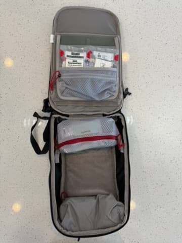 Main compartment of a sling bag with organized preparedness supplies